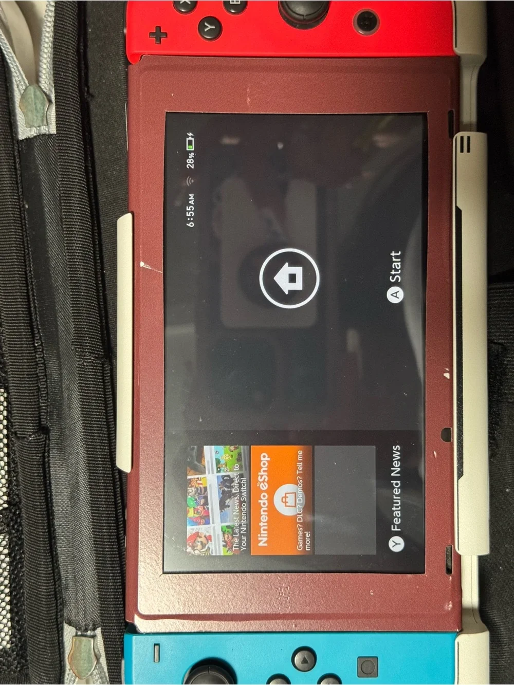 Nintendo Switch with Red and Blue Joy‑Con and Burgundy Front Panel